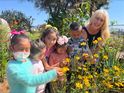 Dr. Rodriguez with students in a garden at PVUSD